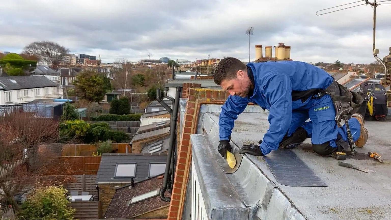 emergency roof repair London worker sealing an open roof edge during a dormer loft conversion