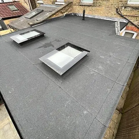 flat roof repair London worker sealing a cracked roof skin
