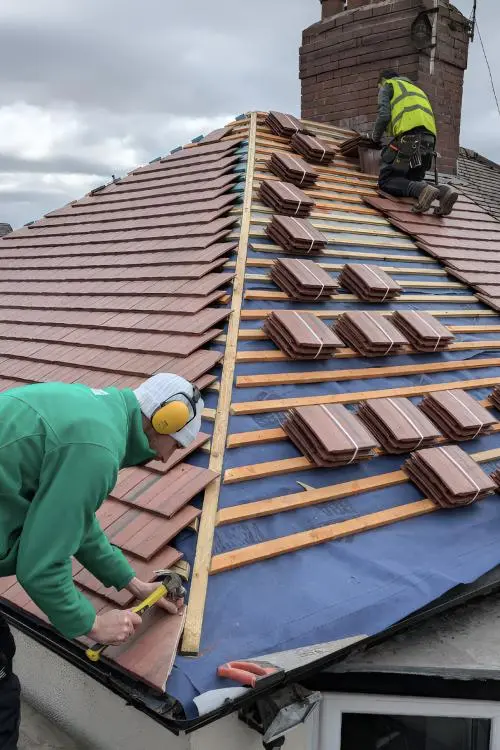 new roof installation London materials including slate and clay tiles ready for fitting