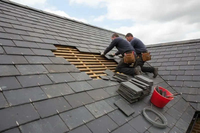 slate roof repair London team checking battens before fitting new stone slates