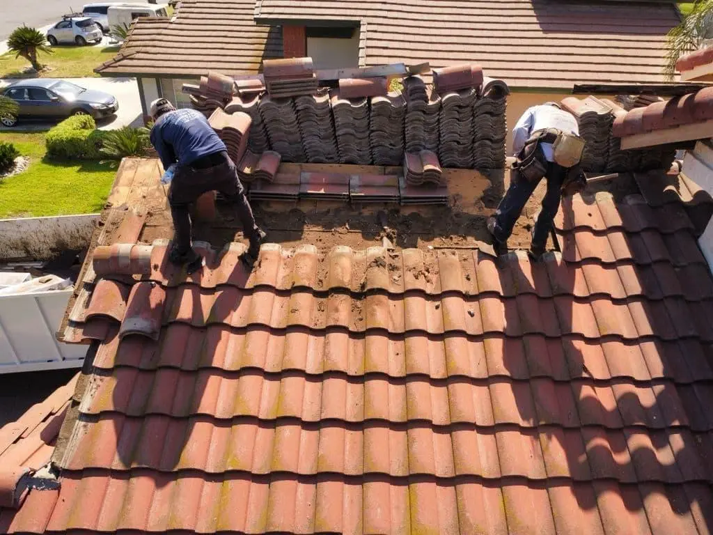 tiled roof repair London team checking timber battens before fitting new tiles